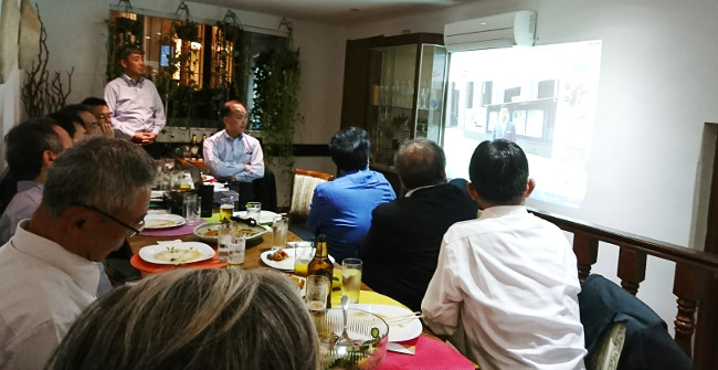 Participants gazing at the video message by President Tsuchiya