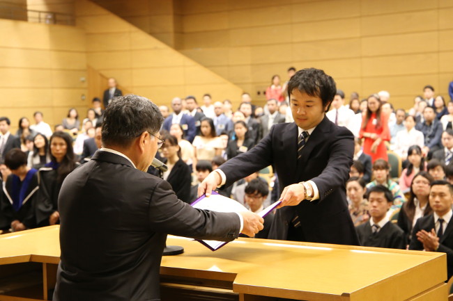 The graduate representative receiving his diploma