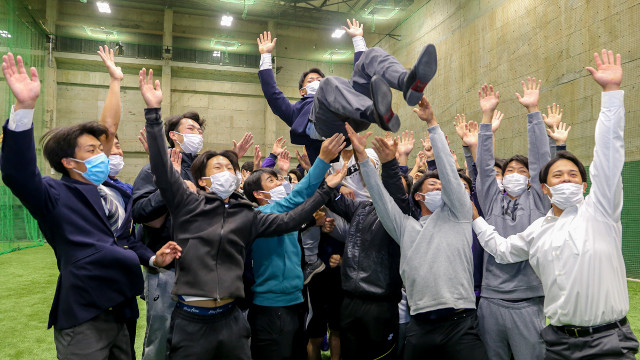 The baseball club members tossed him into the air in celebration of the nomination.