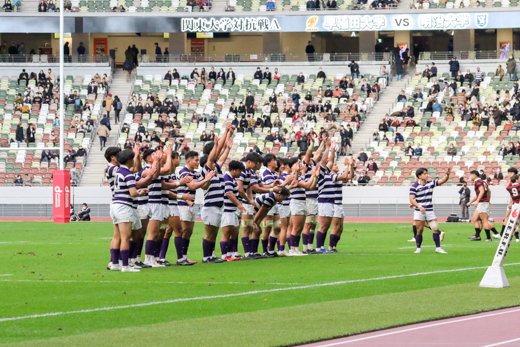 The team greeting the crowd after the match