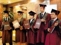 The graduates with their Master's degrees in hand