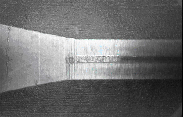 Fig. 3 Flaking of outer sleeve raceway surface (edge)